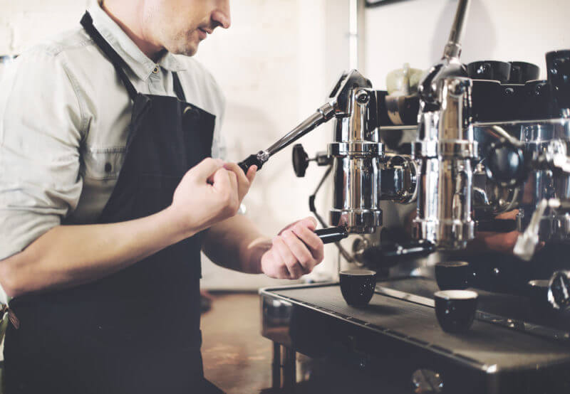 barista wearing black apron