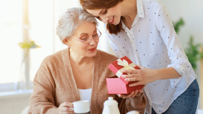woman giving gift to her mother in law