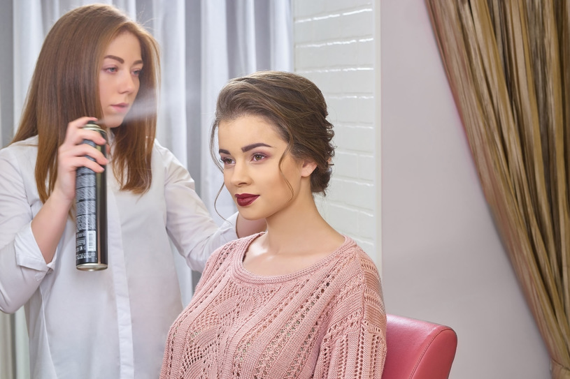 beautiful girl using hairspray