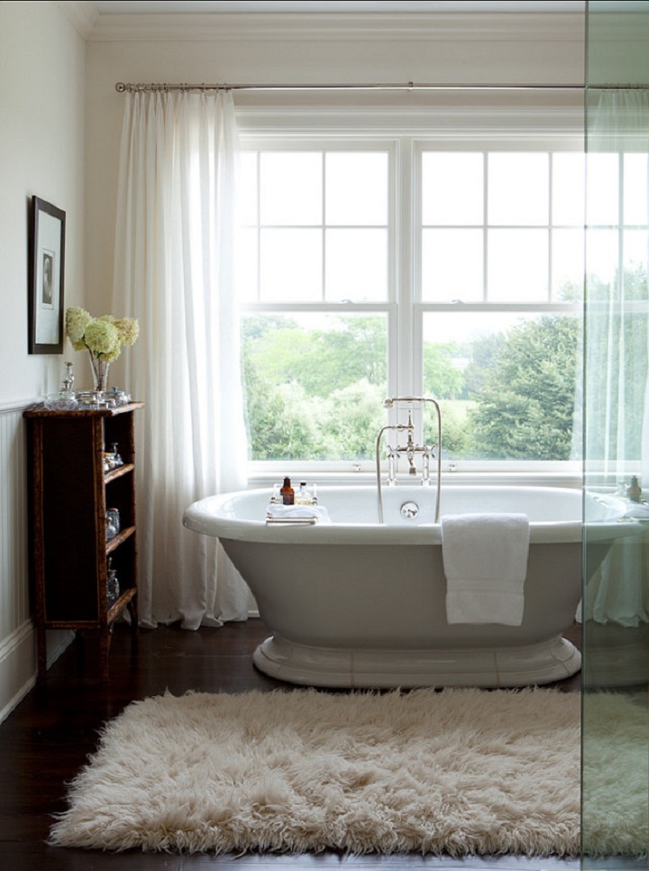 picture of an accessories around the bathtub with a view of nature