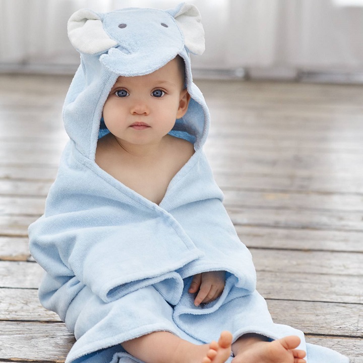 picture of a baby in a blue hooded towel on a wooden floor
