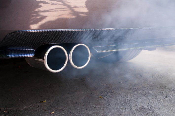 Car exhaust pipe expelling smoke