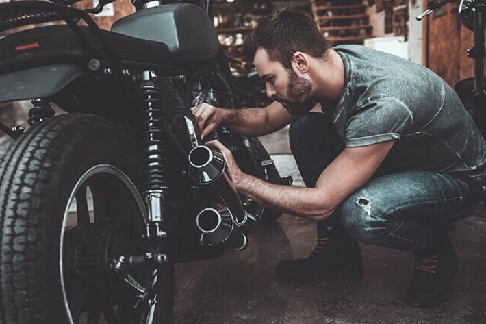 Man checks Moto Parts Condition