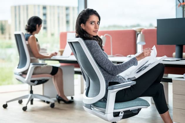 women sitting on task ergonomic office chairs