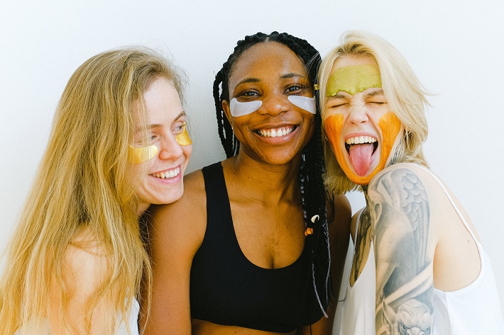 picture of three girls smiling with face masks on