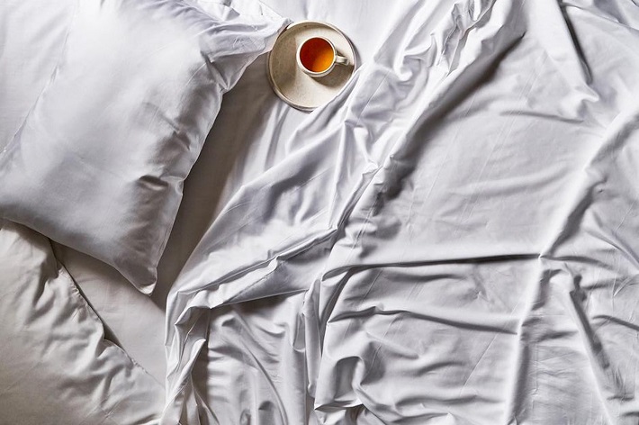 tea on white bed sheets