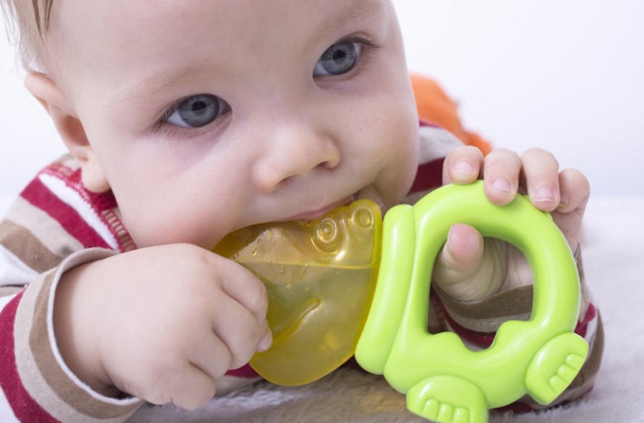 picture of a Baby boy playing with teether, chewing toy