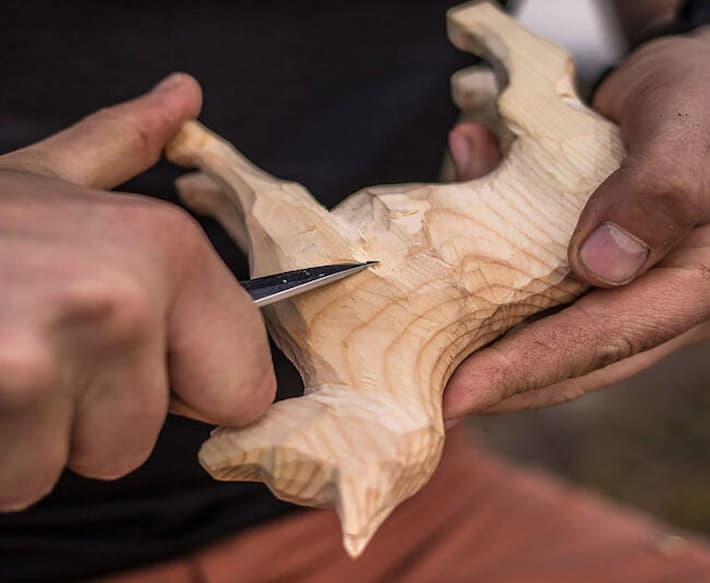 Making wooden animal figure with whittling knife