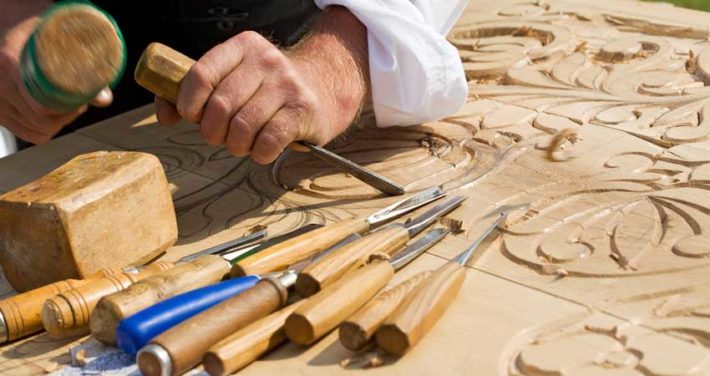 Person making wooden art with Wood Carving Tools
