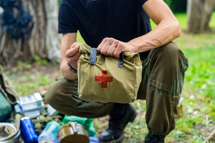 Close-up of hunter holding first aid kit