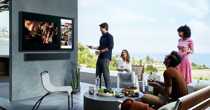 picture of persons sitting around a smart tv