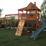 Wooden cubby house with slide and swings