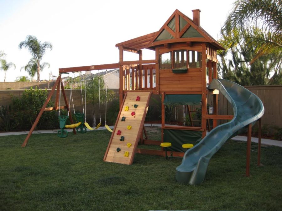 Wooden cubby house with slide and swings