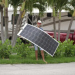 man with flexible solar panels