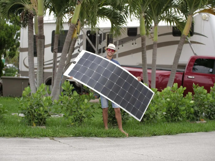 man with flexible solar panels