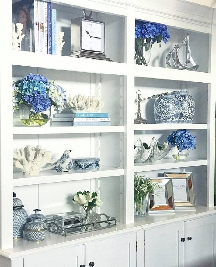 bookshelf decorated with Hampton homewares