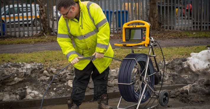 Man using pipe inspection camera