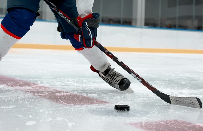 kid playing ice hockey with a junior stick